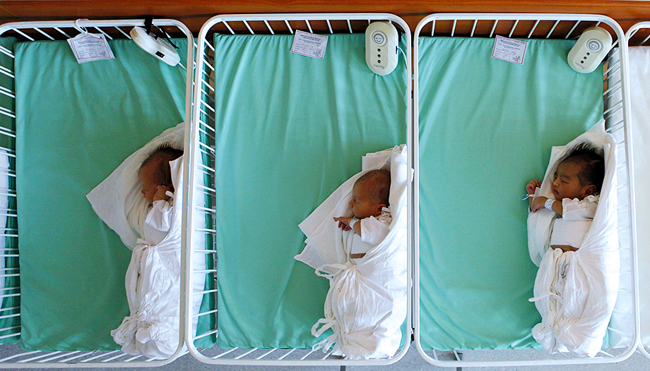 Newborn babies in cribs
