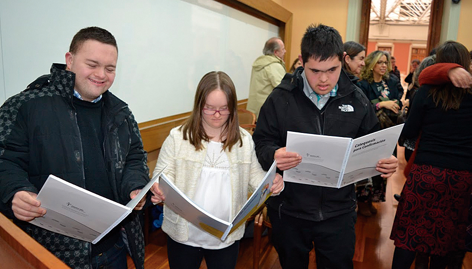 Some young people with disabilities leaf through catechetical materials.