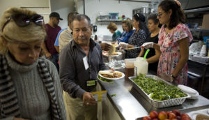 People receiving food at a soup kitchen.