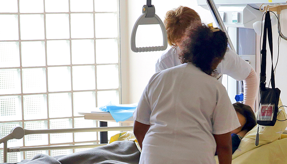 Nurses care for a patient in the intensive care unit of a hospital.