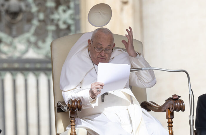 The wind blows away the Pope's skullcap
