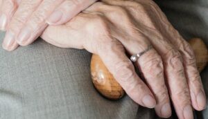 Hands of an elderly woman alone at home